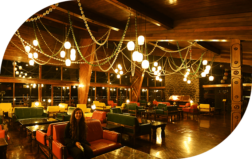 Lady relaxing inside a luxury lodge in Tanzania with stylish interiors and a scenic view.