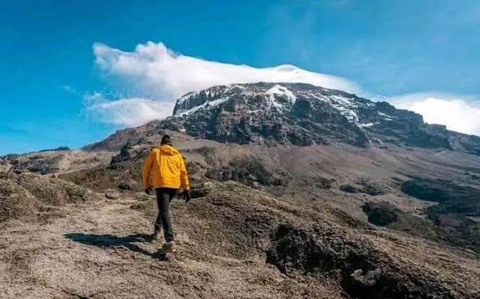 Hikers trekking along the Marangu Route on Mount Kilimanjaro